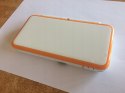 KONSOLA NEW NINTENDO 2DS XL BIAŁO-POMARAŃCZOWA + ŁADOWARKA +RYSIK + PUDEŁKO