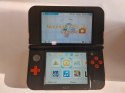 KONSOLA NEW NINTENDO 3DS XL POMARAŃCZOWO-CZARNA + GRA POKEMON MOON + ŁAD